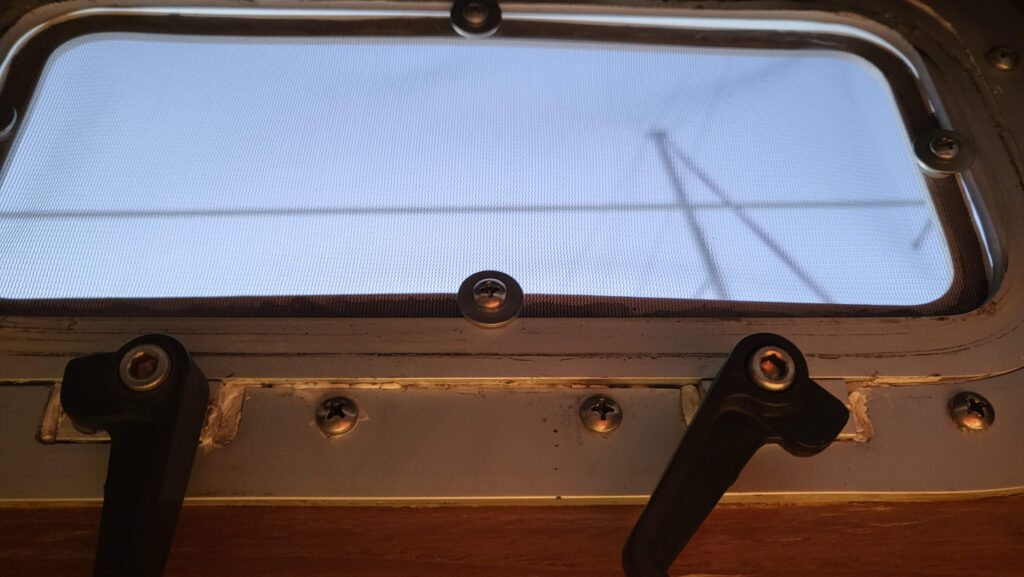 Close up of screen in place showing the screw and washers to hold frame in place.